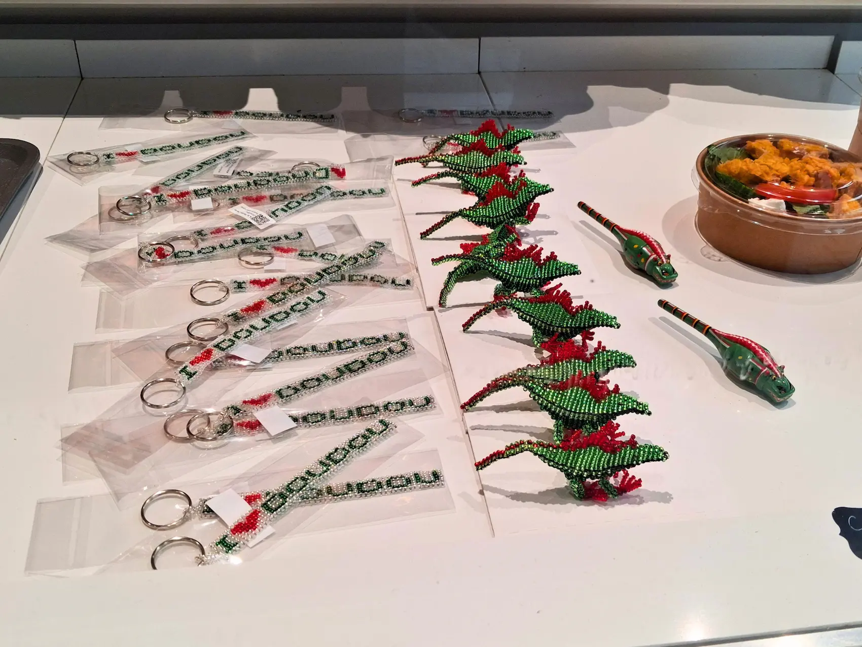 Exposition de dragons en perles de rocaille et porte-clés du Doudou à la Boulangerie Montoise à Mons.